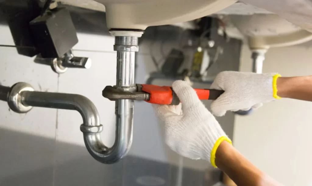 Emergency plumber repairing pipe in Dubai apartment